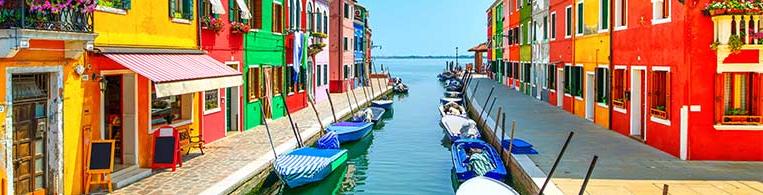 A view of various colorful homes on a canal.